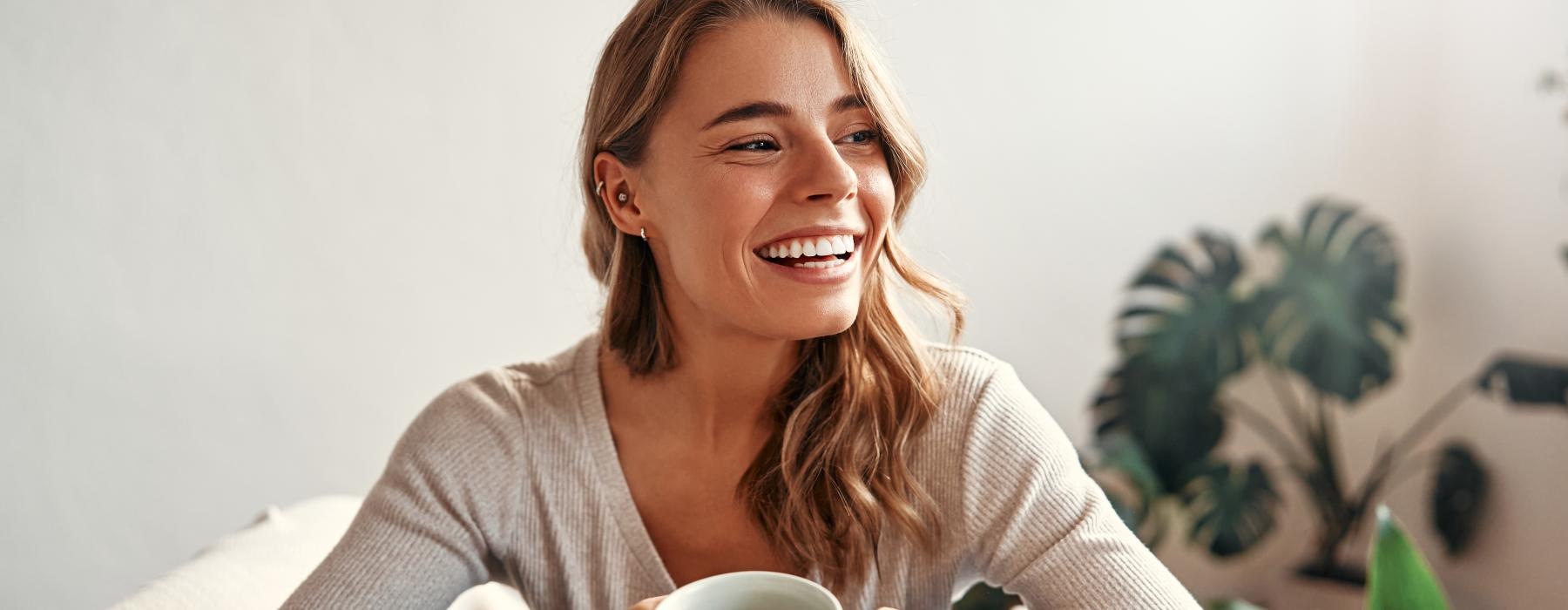 a woman holding a cup