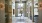 a room with glass doors and a table with flowers on it